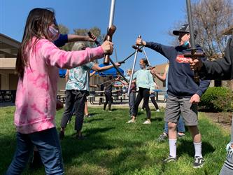 children practicing medieval sword fighting